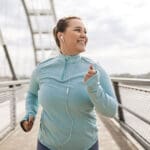 woman jogging on a bridge - How Exercise Can Boost Your Mental Health