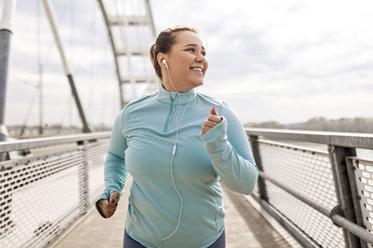 woman jogging on a bridge - How Exercise Can Boost Your Mental Health