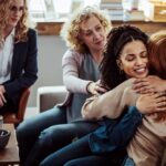 women in group therapy supporting each other