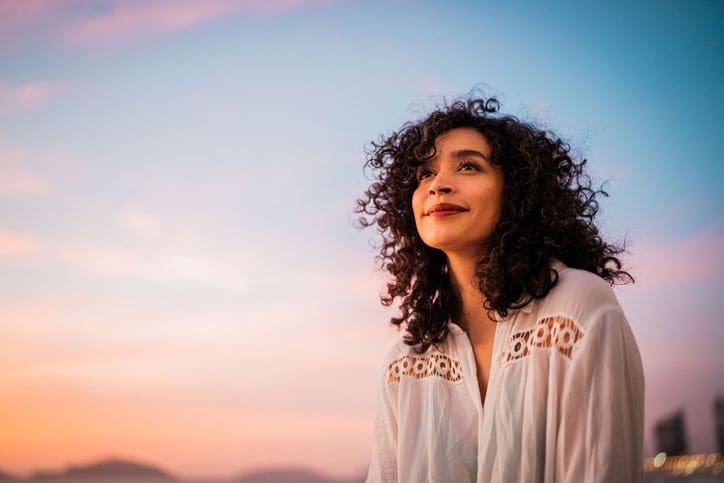 optimistic woman at sunset - empowering women