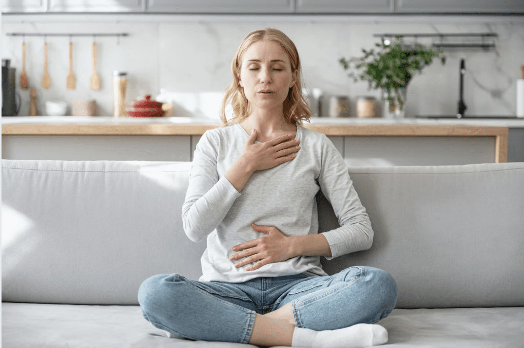 A woman practicing breathing exercises.